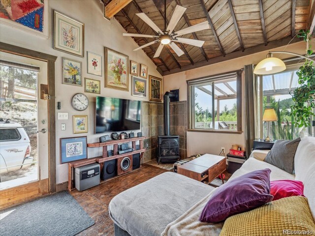 366 Houston St, Bailey, CO 80421 - living room with wood ceiling, a wood stove, beamed ceiling, a ceiling fan, and wood finished floors