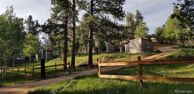 366 Houston St, Bailey, CO 80421 - view of property's community featuring fence, an outdoor structure, and view of wooded area