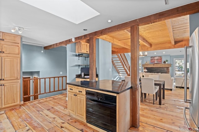 kitchen featuring beam ceiling, light wood-type flooring, light brown cabinets, and wine cooler