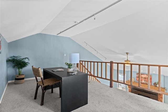 carpeted office with track lighting, vaulted ceiling, and ceiling fan