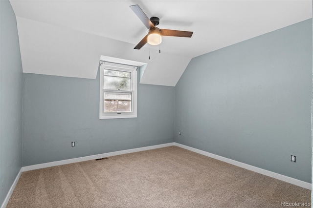 additional living space with carpet flooring, ceiling fan, and lofted ceiling