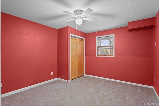 unfurnished bedroom with light carpet, a closet, and ceiling fan