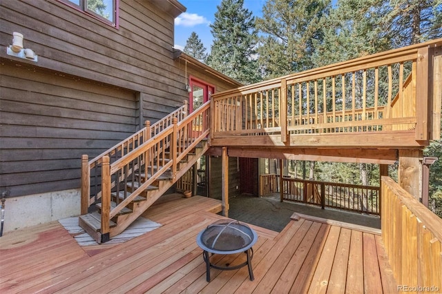 wooden terrace featuring an outdoor fire pit