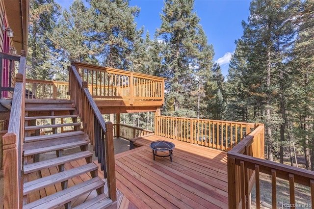 wooden deck featuring an outdoor fire pit