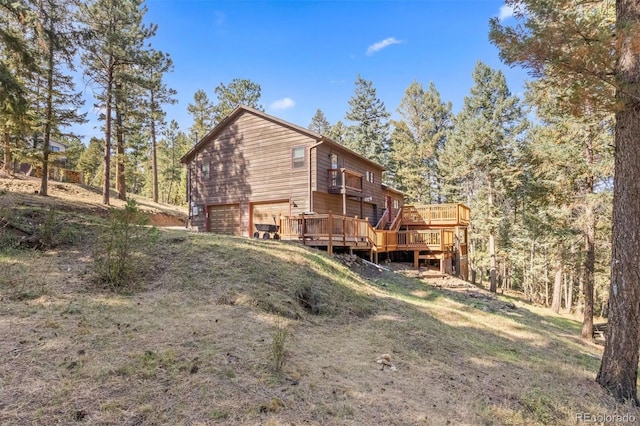 rear view of property featuring a lawn and a garage