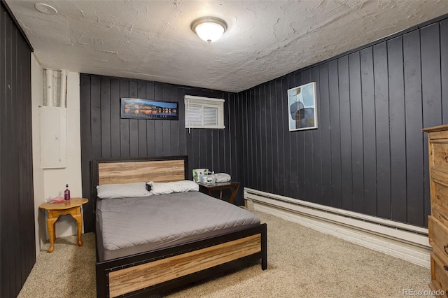 841 Crisman Dr Unit 9, Longmont, CO 80501 - bedroom with a baseboard heating unit, carpet flooring, and wooden walls