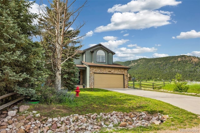 133 Wheat Ridge St, Palmer Lake, CO 80133 - view of front of house featuring stone siding, concrete driveway, a garage, and a mountain view