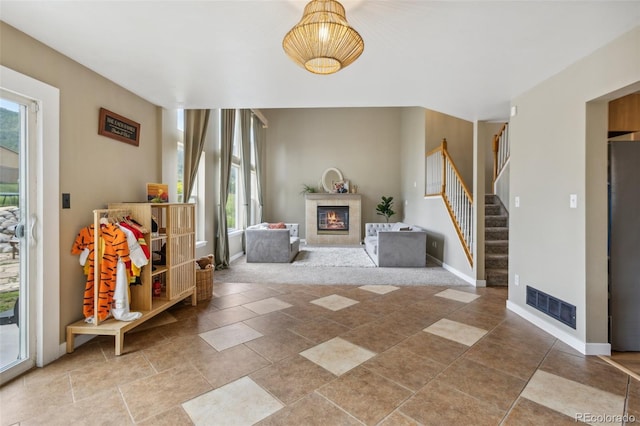 133 Wheat Ridge St, Palmer Lake, CO 80133 - entrance foyer with a glass covered fireplace, healthy amount of natural light, and stairs