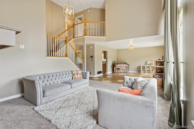 133 Wheat Ridge St, Palmer Lake, CO 80133 - carpeted living area with stairs, a towering ceiling, and a chandelier