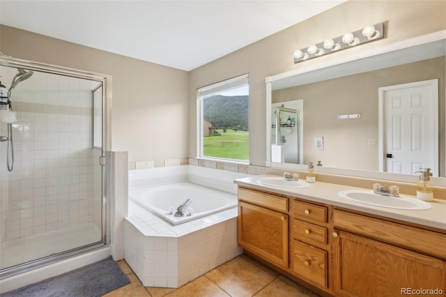 133 Wheat Ridge St, Palmer Lake, CO 80133 - full bath with tile patterned flooring, a stall shower, double vanity, and a garden tub
