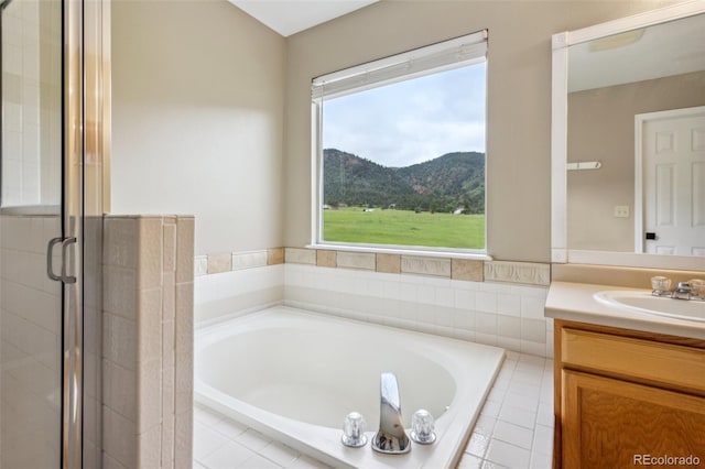 133 Wheat Ridge St, Palmer Lake, CO 80133 - full bath featuring vanity, a bath, a mountain view, and a shower stall