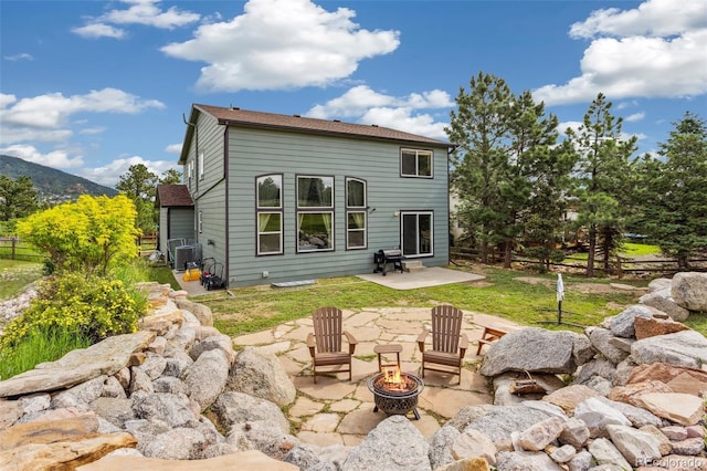 133 Wheat Ridge St, Palmer Lake, CO 80133 - back of house with an outdoor fire pit, a patio area, and a mountain view