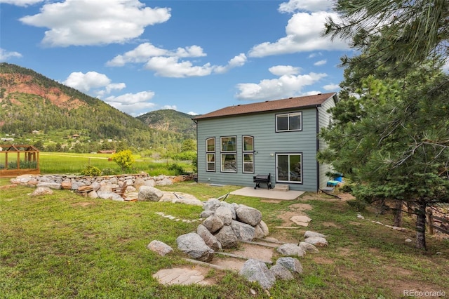 133 Wheat Ridge St, Palmer Lake, CO 80133 - back of house with a mountain view, a patio, a yard, and a greenhouse
