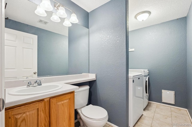 14625 Vine St, Thornton, CO 80602 - bathroom with washing machine and dryer, vanity, a textured wall, tile patterned floors, and a chandelier