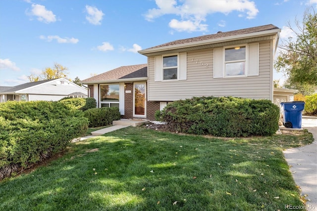 tri-level home with a front yard