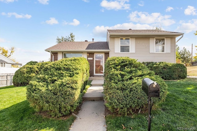 split level home with a front lawn