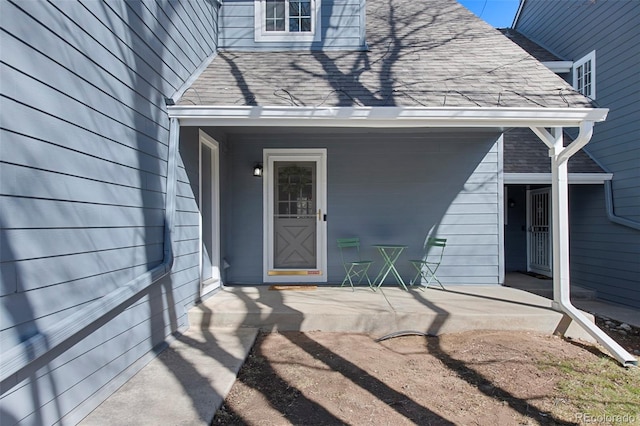 entrance to property with roof with shingles