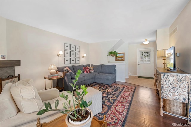 living room with visible vents and hardwood / wood-style flooring