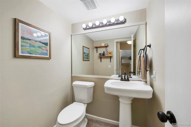 bathroom featuring visible vents, toilet, and tile patterned floors