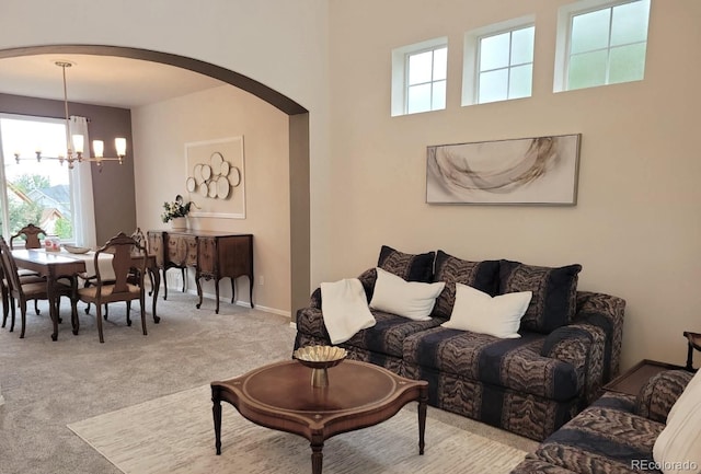 22386 E Arbor Pl, Aurora, CO 80016 - carpeted living room featuring arched walkways and a chandelier