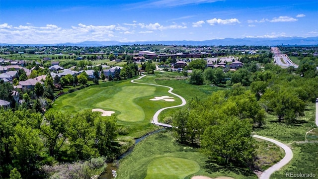 22386 E Arbor Pl, Aurora, CO 80016 - aerial overview of property's location with a golf course, nearby suburban area, and a mountain backdrop
