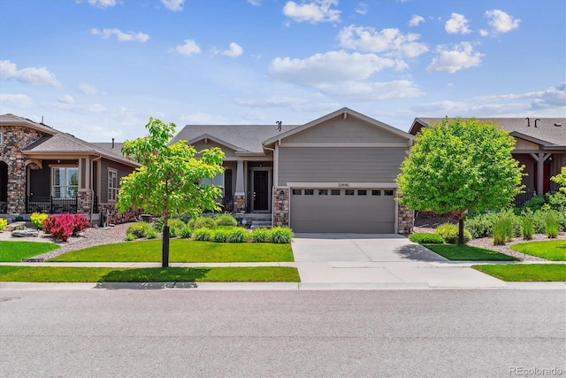 22656 E Glidden Dr, Aurora, CO 80016 - view of front facade with concrete driveway, stone siding, a garage, and a front lawn