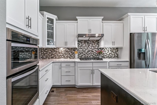 22656 E Glidden Dr, Aurora, CO 80016 - kitchen featuring appliances with stainless steel finishes, white cabinets, dark wood-style floors, and glass insert cabinets