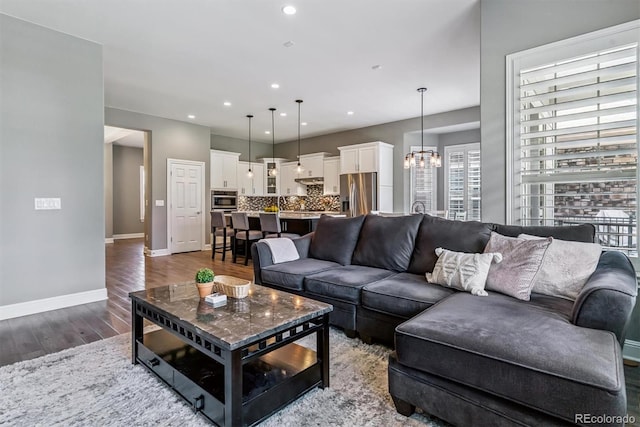 22656 E Glidden Dr, Aurora, CO 80016 - living area featuring wood finished floors, a chandelier, and recessed lighting
