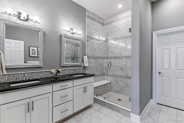 22656 E Glidden Dr, Aurora, CO 80016 - bathroom with marble look tiles, double vanity, a shower stall, and recessed lighting