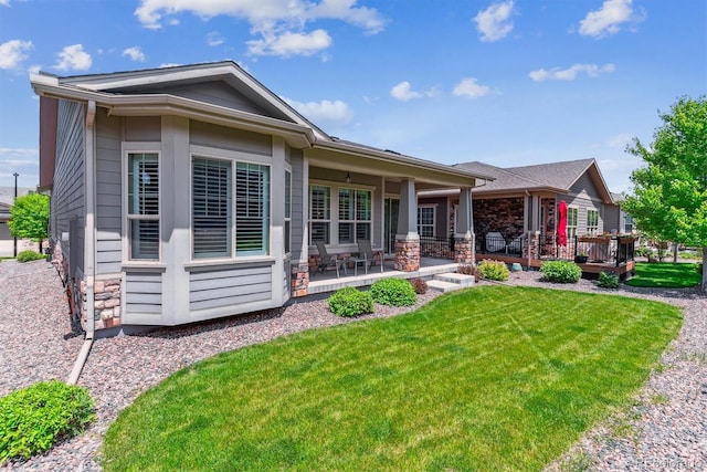 22656 E Glidden Dr, Aurora, CO 80016 - view of front of house featuring stone siding and a front yard