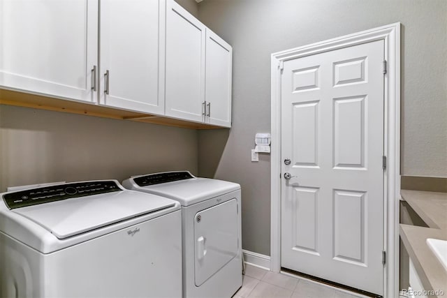 22656 E Glidden Dr, Aurora, CO 80016 - laundry room featuring washing machine and dryer, cabinet space, and light tile patterned floors