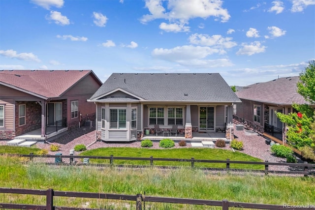 22656 E Glidden Dr, Aurora, CO 80016 - back of property featuring a patio, roof with shingles, and stone siding