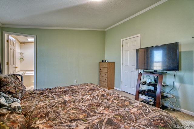 carpeted bedroom featuring a textured ceiling, crown molding, and ensuite bath