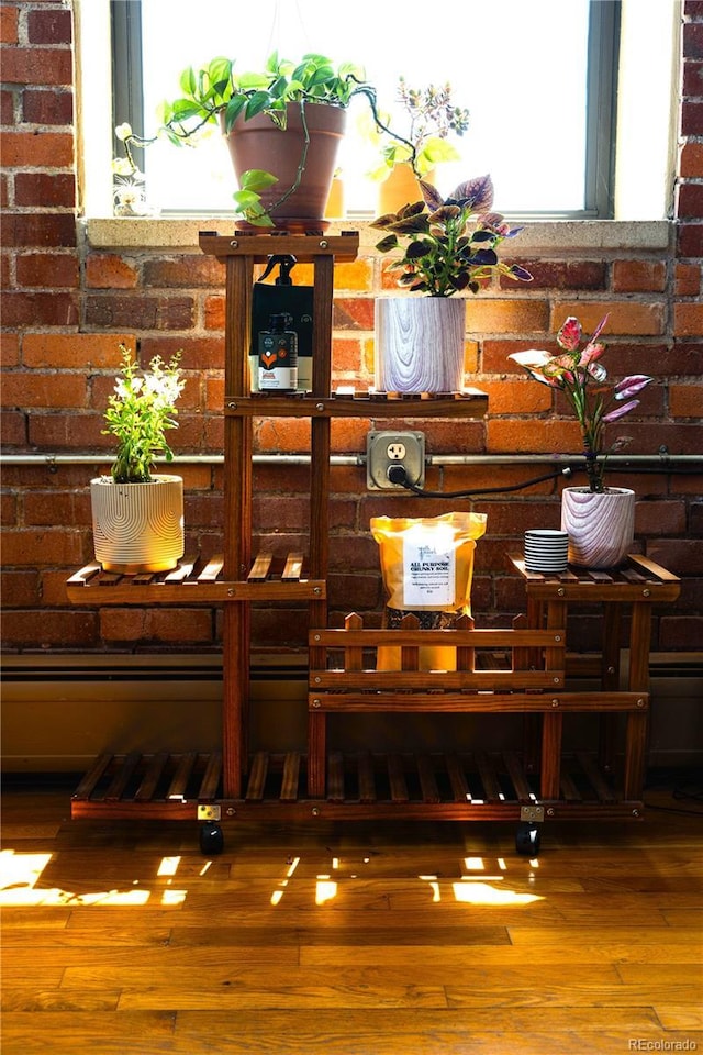 2261 Blake St Unit 5H, Denver, CO 80205 - detailed view of wood finished floors and brick wall