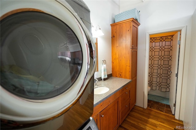2261 Blake St Unit 5H, Denver, CO 80205 - bathroom with washer / clothes dryer, vanity, and wood finished floors