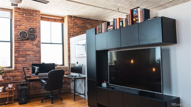 2261 Blake St Unit 5H, Denver, CO 80205 - office with light wood finished floors, brick wall, and ceiling fan