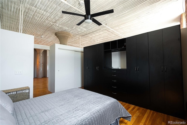 2261 Blake St Unit 5H, Denver, CO 80205 - bedroom featuring wood finished floors, a ceiling fan, and a closet