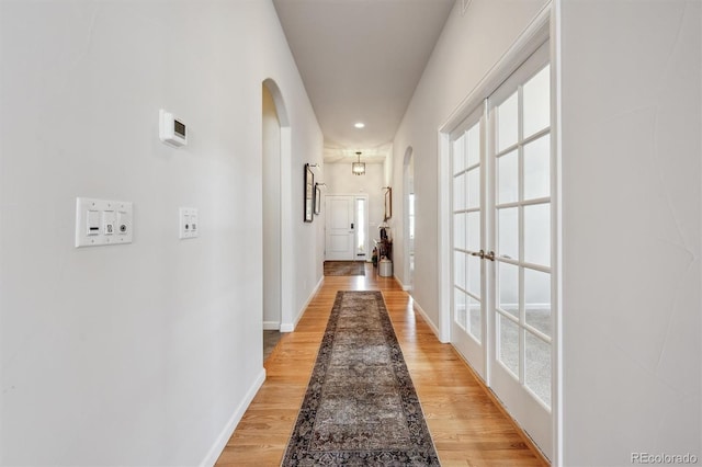 18926 W 94th Ave, Arvada, CO 80007 - corridor with arched walkways and light wood-type flooring