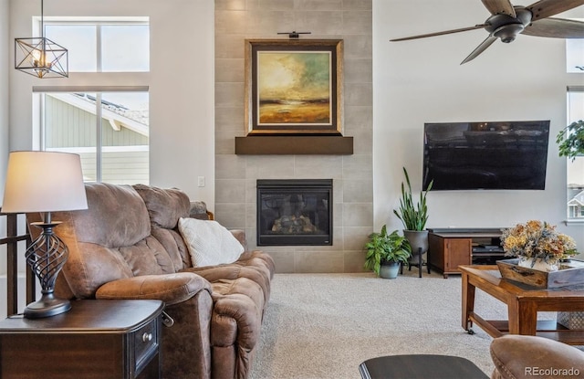 18926 W 94th Ave, Arvada, CO 80007 - living room featuring ceiling fan, a tile fireplace, and carpet flooring