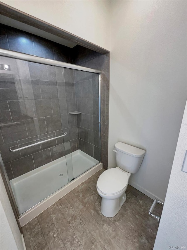 bathroom featuring toilet and walk in shower