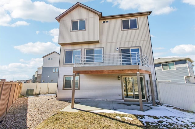 back of house with a balcony and a patio area