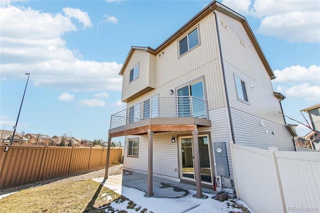 back of property with a patio area and a balcony