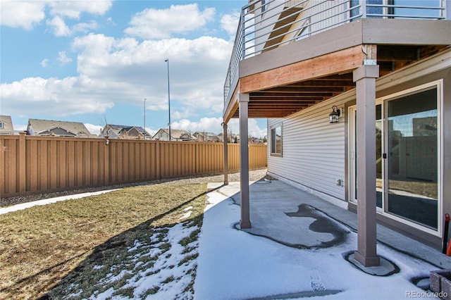 yard layered in snow featuring a patio area