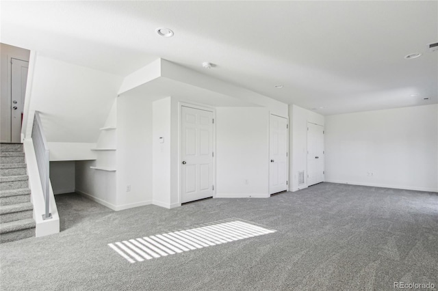 additional living space featuring carpet