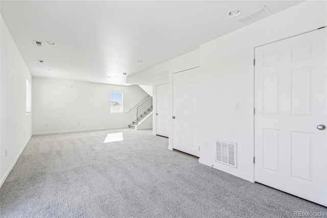 empty room featuring light carpet