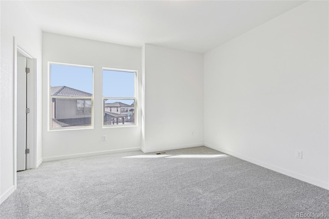 unfurnished room featuring light colored carpet