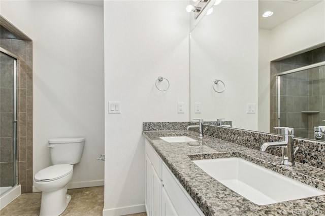 bathroom featuring an enclosed shower, vanity, tile patterned floors, and toilet