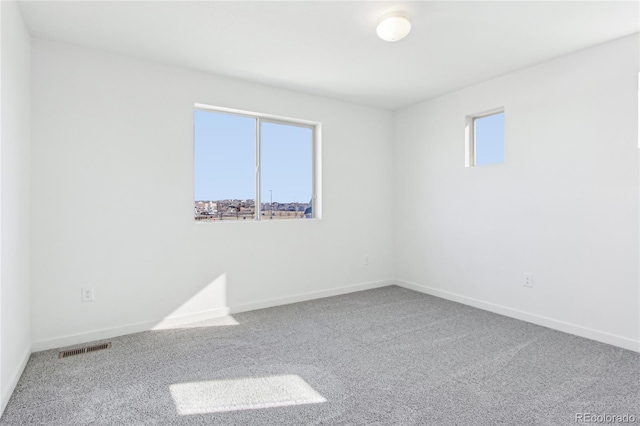 carpeted spare room with plenty of natural light