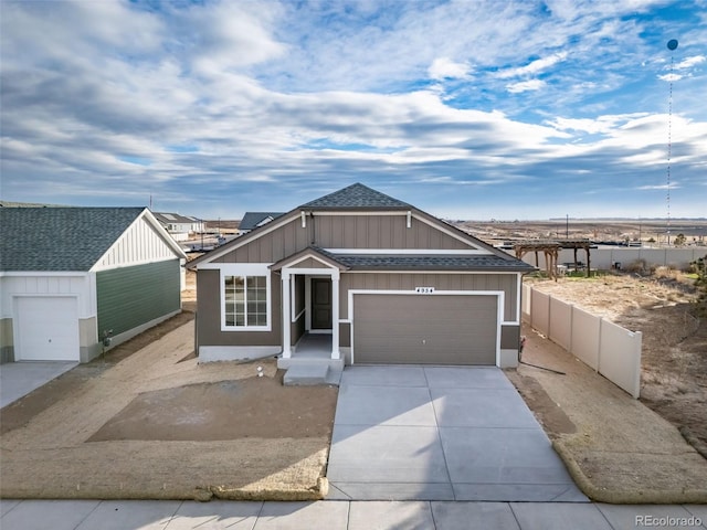 22384 E 49th Pl, Aurora, CO 80019 - view of front of house with roof with shingles, concrete driveway, and an attached garage