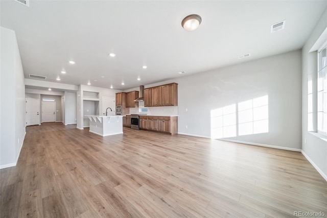 22384 E 49th Pl, Aurora, CO 80019 - unfurnished living room with recessed lighting and light wood-type flooring